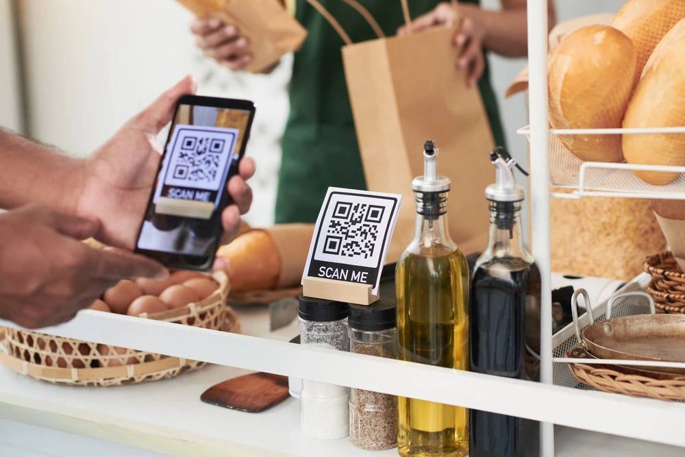 A shopper scanning a QR code at a bakery counter
