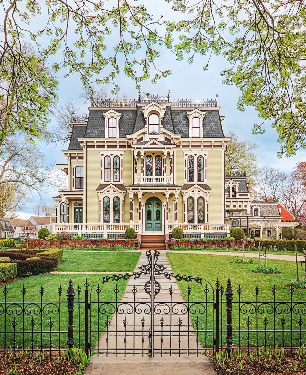A restored Victorian house behind an iron gate in Wethersfield