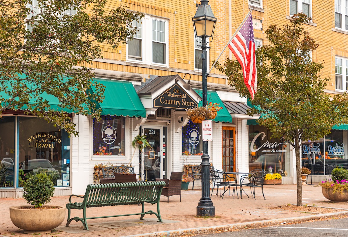 Main Street Old Wethersfield — historic storefronts with an American flag